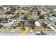 Aerial shot showcasing the home's location within a lush neighborhood near mature trees and other residences at 506 8Th Ave Sw, Largo, FL 33770