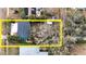 Aerial view of the home and lot surrounded by trees, offering privacy and a natural setting at 506 8Th Ave Sw, Largo, FL 33770