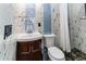 Bathroom featuring stylish tiles, corner sink, and a modern toilet at 506 8Th Ave Sw, Largo, FL 33770