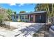 Charming single-story home with a brick front door, dark shutters, and palm tree landscaping at 506 8Th Ave Sw, Largo, FL 33770