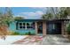 Charming single-story home featuring a brick facade, manicured yard, and inviting entrance at 506 8Th Ave Sw, Largo, FL 33770