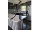 Kitchen featuring white countertops with custom wood look base, stainless steel appliances, and stylish gray cabinets at 506 8Th Ave Sw, Largo, FL 33770