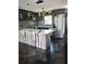 Modern kitchen with gray cabinets, tile backsplash, stainless steel appliances, and a wooden kitchen island at 506 8Th Ave Sw, Largo, FL 33770