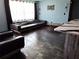Stylish living area features a leather sofa, chair, painted blue walls, and unique decorations, creating a modern aesthetic at 506 8Th Ave Sw, Largo, FL 33770