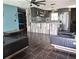 Stylish living room with modern furniture, tile floors, and an open view to the kitchen at 506 8Th Ave Sw, Largo, FL 33770