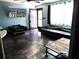 Living room features a leather sofa, chair, painted blue walls, and dark tile flooring, creating a cozy and stylish space at 506 8Th Ave Sw, Largo, FL 33770