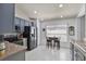 Well-lit kitchen with modern stainless steel appliances, tile flooring, and breakfast nook at 548 Sea Holly Dr, Brooksville, FL 34604