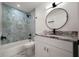 Stylish bathroom featuring marble tile, modern fixtures, and a vanity with stone countertop at 5803 Mohr Loop, Tampa, FL 33615