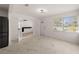 Bright living room with marble floors, fireplace, white walls, and views through large windows at 5803 Mohr Loop, Tampa, FL 33615