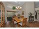 Cozy dining room with wood table, chandelier, and sliding glass door access at 6152 Clark Lake Dr, New Port Richey, FL 34655