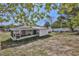 Shot of the home's screened-in lanai and white fence, viewed from the backyard at 6343 Skyline Ct, Spring Hill, FL 34606