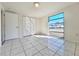 Well-lit bedroom with tile flooring, closet, and a large window at 7421 San Miguel Dr, Port Richey, FL 34668