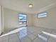 Spacious bedroom with tile flooring, two windows letting in natural light at 7421 San Miguel Dr, Port Richey, FL 34668