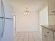 Cozy dining area adjacent to the kitchen, illuminated by a modern chandelier at 7421 San Miguel Dr, Port Richey, FL 34668