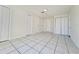 Hallway featuring multiple doors and tile flooring at 7421 San Miguel Dr, Port Richey, FL 34668
