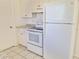 Efficient kitchen setup with white appliances, clean countertops, and ample cabinet space at 7421 San Miguel Dr, Port Richey, FL 34668