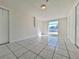 Spacious room featuring tile flooring, a window, and neutral walls at 7421 San Miguel Dr, Port Richey, FL 34668