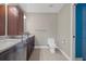 Bright bathroom with granite countertop, dark wood cabinets and tile flooring at 7485 Sugarbush Dr, Spring Hill, FL 34606