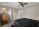 Comfortable bedroom featuring a ceiling fan, a white closet door, and carpeted floors at 7485 Sugarbush Dr, Spring Hill, FL 34606