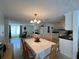 Open-concept dining area connecting to the kitchen, featuring a table setting and abundant natural light at 7535 Valencia Ave, Port Richey, FL 34668