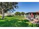 Lush backyard with mature trees, perfect for outdoor activities and relaxation, plus a patio at 8110 Bismark Ct, Port Richey, FL 34668