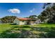Beautiful backyard featuring a well-maintained lawn and a screened-in lanai for outdoor relaxation at 8110 Bismark Ct, Port Richey, FL 34668