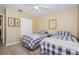 Bright bedroom with twin beds, tiled floors, and closet at 8110 Bismark Ct, Port Richey, FL 34668