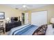 Serene bedroom with blue bedding, dark furniture, and a mirrored closet at 8110 Bismark Ct, Port Richey, FL 34668