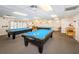 Billiards room has carpeted floors, recessed lighting, drop ceiling, and three diamond pool tables at 8110 Bismark Ct, Port Richey, FL 34668