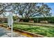 Bocce ball court with seating, a scoreboard, and green space for outdoor leisure and community activities at 8110 Bismark Ct, Port Richey, FL 34668