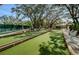 Well-maintained bocce ball courts with benches, surrounded by lush trees at 8110 Bismark Ct, Port Richey, FL 34668