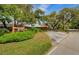 Timber Oaks Clubhouse entrance with well-manicured landscaping, offering a welcoming and serene setting at 8110 Bismark Ct, Port Richey, FL 34668