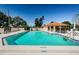 Community pool with lounge chairs and shaded pavilion, perfect for residents to relax and enjoy the Florida sunshine at 8110 Bismark Ct, Port Richey, FL 34668