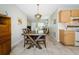 Open concept dining area with wooden table set and decor, blending seamlessly into the living room at 8110 Bismark Ct, Port Richey, FL 34668