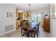 Cozy dining area featuring a wooden table with chairs, open to kitchen and a view to the screened patio at 8110 Bismark Ct, Port Richey, FL 34668