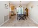 Dining area with a wooden table, tile floor, and natural light from the sliding door at 8110 Bismark Ct, Port Richey, FL 34668