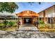 The entrance to the building has a covered awning, a landscaped garden bed, and manicured shrubs at 8110 Bismark Ct, Port Richey, FL 34668