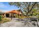Welcoming entrance with an orange awning, landscaping, and well-maintained grounds at 8110 Bismark Ct, Port Richey, FL 34668