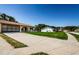 A wide shot of the home exterior and expansive driveway and well-maintained lawn at 8110 Bismark Ct, Port Richey, FL 34668