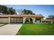 Charming single-story home with a clay tile roof and a well-manicured front lawn at 8110 Bismark Ct, Port Richey, FL 34668