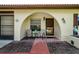 Covered front porch with seating and a well manicured landscape and unique architecture at 8110 Bismark Ct, Port Richey, FL 34668