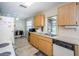 Well-lit kitchen with classic wood cabinets, neutral countertops, and practical appliances at 8110 Bismark Ct, Port Richey, FL 34668
