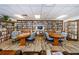 Library with reading areas, wooden tables, laminate floors and floor to ceiling bookshelves at 8110 Bismark Ct, Port Richey, FL 34668