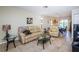 Open living space with neutral tones, comfortable seating and an open flow to the dining area at 8110 Bismark Ct, Port Richey, FL 34668