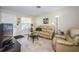Inviting living room with tile floors, neutral colors, and ample natural light at 8110 Bismark Ct, Port Richey, FL 34668