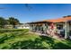 Rear patio with brick trim, perfect for outdoor dining or relaxing with a view of the lush green lawn at 8110 Bismark Ct, Port Richey, FL 34668