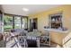 Relaxing sunroom filled with natural light, offering tranquil backyard views and comfortable seating at 8110 Bismark Ct, Port Richey, FL 34668