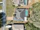 Birds eye view of a well maintained home with an enclosed pool and a paved driveway at 8173 Wysocki Ct, Spring Hill, FL 34606