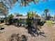 A screened-in pool is surrounded by lush tropical plants, creating a private backyard oasis at 8173 Wysocki Ct, Spring Hill, FL 34606