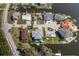 Aerial view of waterfront home showcasing its location and private dock with access to deep water at 8401 Carolyn Dr, Port Richey, FL 34668